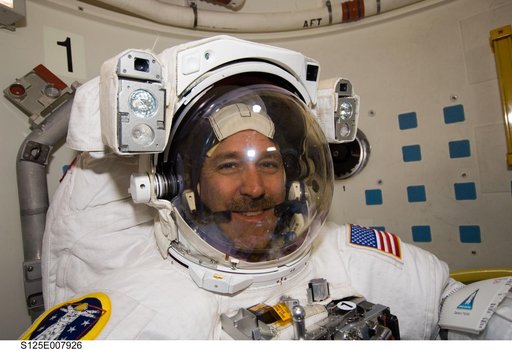 STS-125 MS3 Grunsfeld poses for a photo in the Airlock prior to EVA3