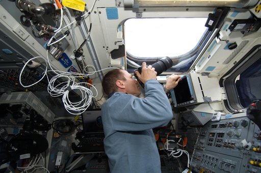 STS-125 Pilot Johnson takes photos on the aft FD during Flight Day 6
