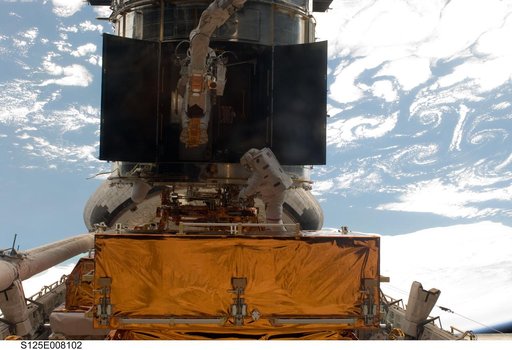 STS-125 MS5 Feustel and MS3 Grunsfeld during EVA3
