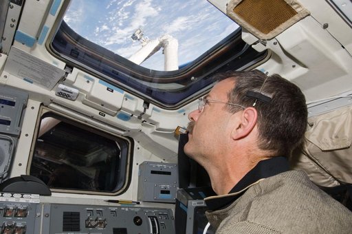 STS-125 CDR Scott Altman works on the Atlantis Flight Deck