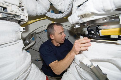STS-125 MS5 Feustel works with an EMU
