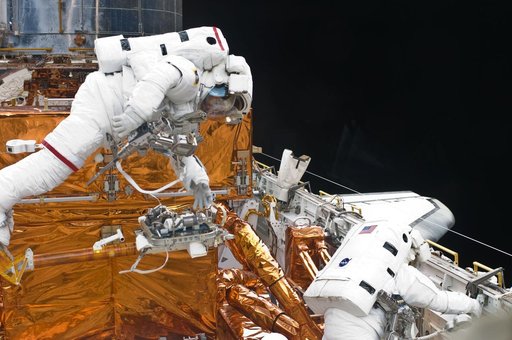 STS-125 MS3 Grunsfeld and MS5 Feustel during EVA5