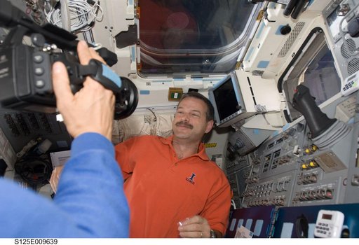 STS-125 Crew Members on the Flight Deck during Flight Day 8