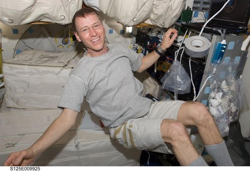 STS-125 Pilot Gregory Johnson poses for a photo on the Middeck