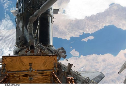STS-125 MS3 Grunsfeld and MS5 Feustel during EVA5