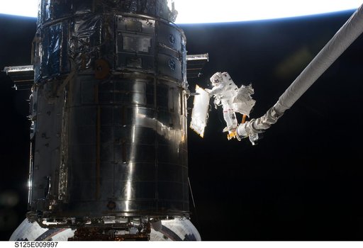 STS-125 MS3 Grunsfeld and MS5 Feustel during EVA5