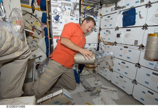 STS-125 CDR Scott Altman replaces LiOH Cannisters on the Shuttle Atlantis Middeck
