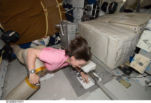 STS-125 MS2 McArthur works with the LiOH Cannisters on the Middeck