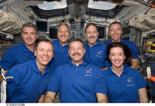 STS-125 Crew Members pose for a photo on the Flight Deck