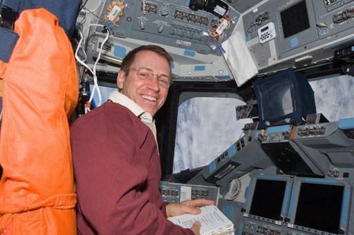 View of Pilot Gregory Johnson posing for a photo on the Flight Deck