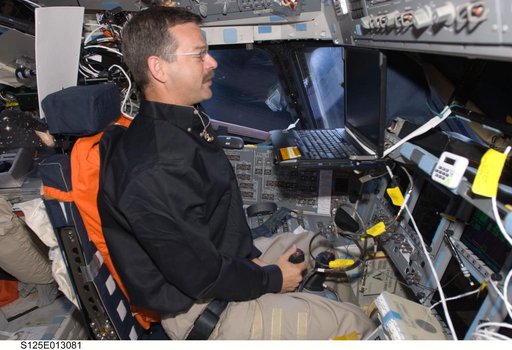 View of Commander (CDR) Scott Altman working on the Flight Deck