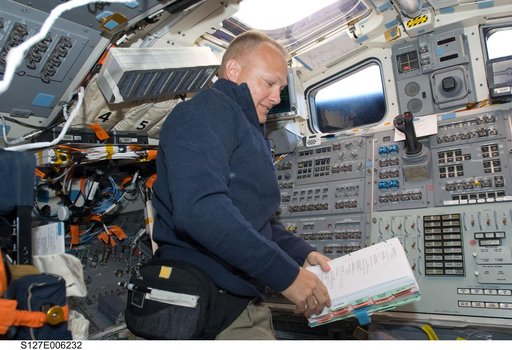 Hurley looks at procedures in the aft FD on the Space Shuttle Endeavour during the STS-127 Mission
