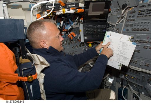 Hurley looks at crew procedures in the aft FD on Space Shuttle Endeavour during the STS-127 Mission