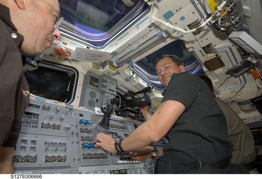 Polansky, Marshburn, and Cassidy in the aft FD during docking activities of Space Shuttle Endeavour