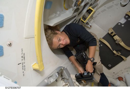 Payette holds camera in the A/L after docking with ISS during STS-127 Mission