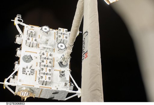 SRMS moves JEF during EVA-1 on STS-127 / Expedition 20 Joint Operations