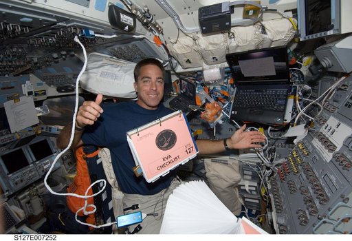 Cassidy watches a checklist float in the FD during STS-127 / Expedition 20 Joint Operations