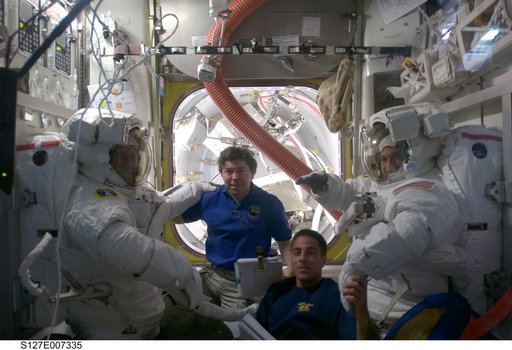 Cassidy waves to camera during EVA-2 Preparation in the A/L during Joint Operations