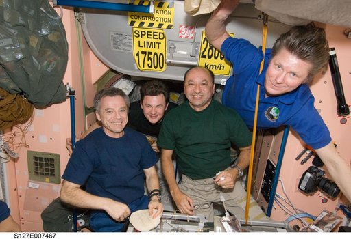 STS-127 / Expedition 20 Crewmembers eating in the Node 1 during Joint Operations