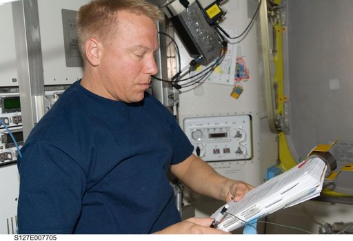 Kopra looks at Crew Procedures in the A/L during EVA-3