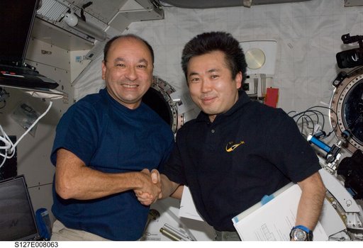 Polansky and Wakata shake hands in the JPM during Joint Operations