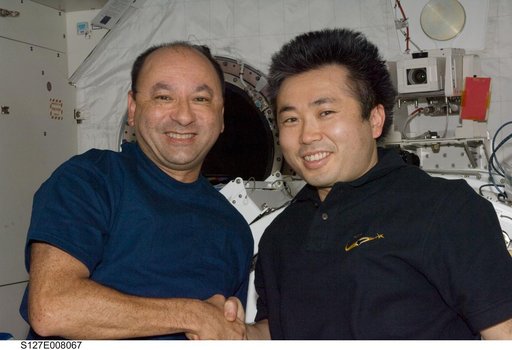 Polansky and Wakata shake hands in the JPM during Joint Operations