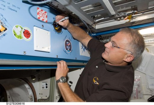 Wolf signs mission decal in the JEM during Joint Operations