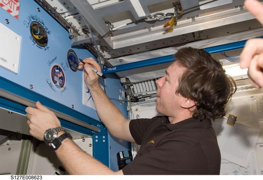 Barratt signs mission decal in the JEM during Joint Operations
