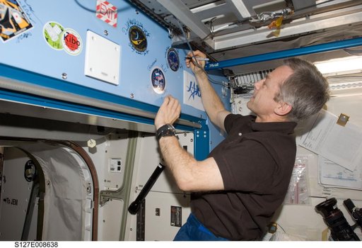 Thirsk signs mission decal in the JEM during Joint Operations