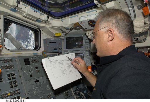 Wolf looks at crew procedures in the aft FD of Endeavour during Joint Operations