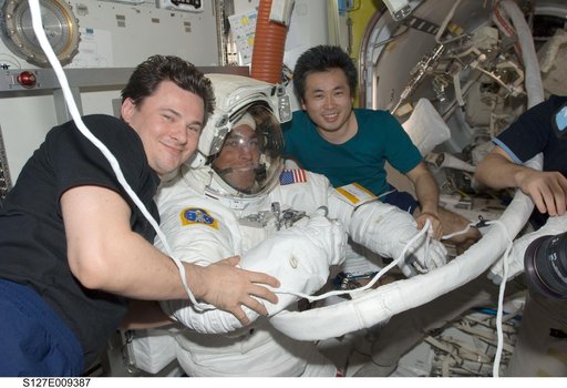 Romanenko and Wakata pose with Cassidy in the A/L after EVA-5