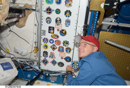 Sturckow adds STS-128 crew patch to wall in Node 1 Unity