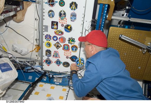 Sturckow adds STS-128 crew patch to wall in Node 1 Unity
