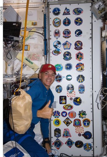 Crew poses at patch wall in Node 1
