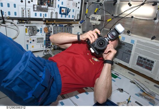 View of CDR Hobaugh working on the Middeck