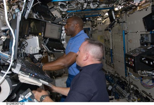 STS-129 Crew Members control the SSRMS during EVA1