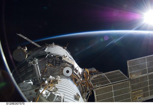 Exterior view of the Service Module backdropped by Earth's Limb