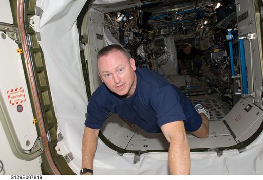 View of STS-129 Pilot Wilmore posing for a photo on the ISS