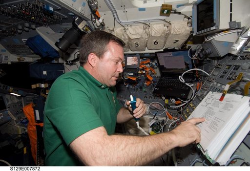 STS-129 MS3 Foreman monitors EVA3 from the Atlantis Flight Deck