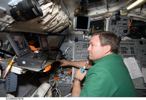 STS-129 MS3 Foreman monitors EVA3 from the Atlantis Flight Deck