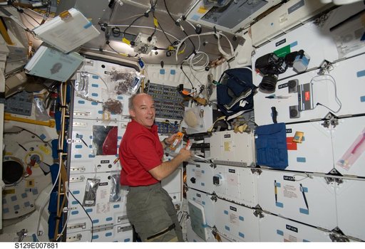 Expedition 21 FE-5 Williams is pictured on the Atlantis Flight Deck during Joint Operations