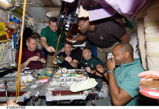 STS-129/Expedition 21 Crew Members enjoy a meal together in the Node 1