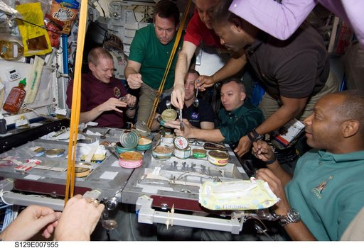 STS-129/Expedition 21 Crew Members enjoy a meal together in the Node 1