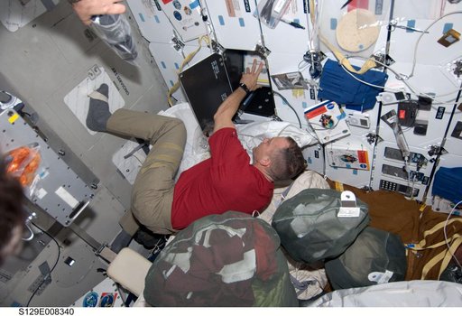 CDR Hobaugh works to stow equipment on the Atlantis Middeck