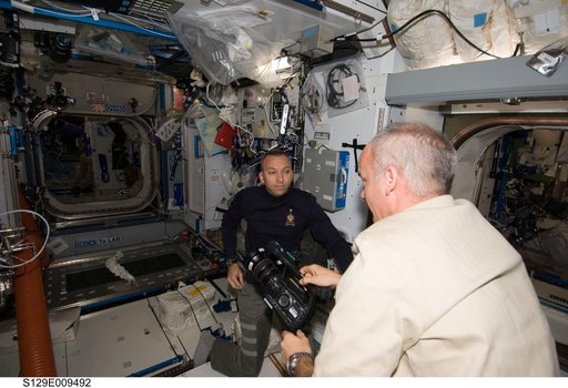 View of Expedition 21 and STS-129 Crew Members working in the Node 2