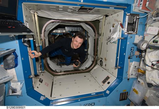 View of Expedition 21 FE-3 Romanenko posing for a photo in the US Laboratory