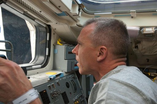 View of STS-134 MS Feustel working on the Flight Deck