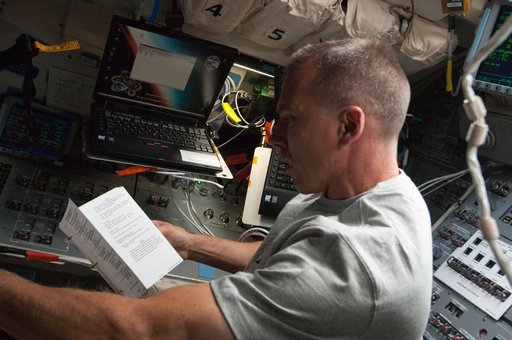 View of STS-134 MS Feustel working on the Flight Deck