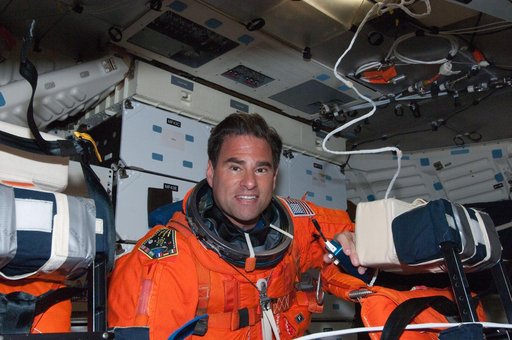 View of STS-134 MS Chamitoff posing for a photo on the Middeck