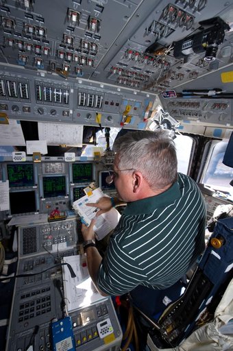 View of STS-134 Pilot Johnson working on the Flight Deck